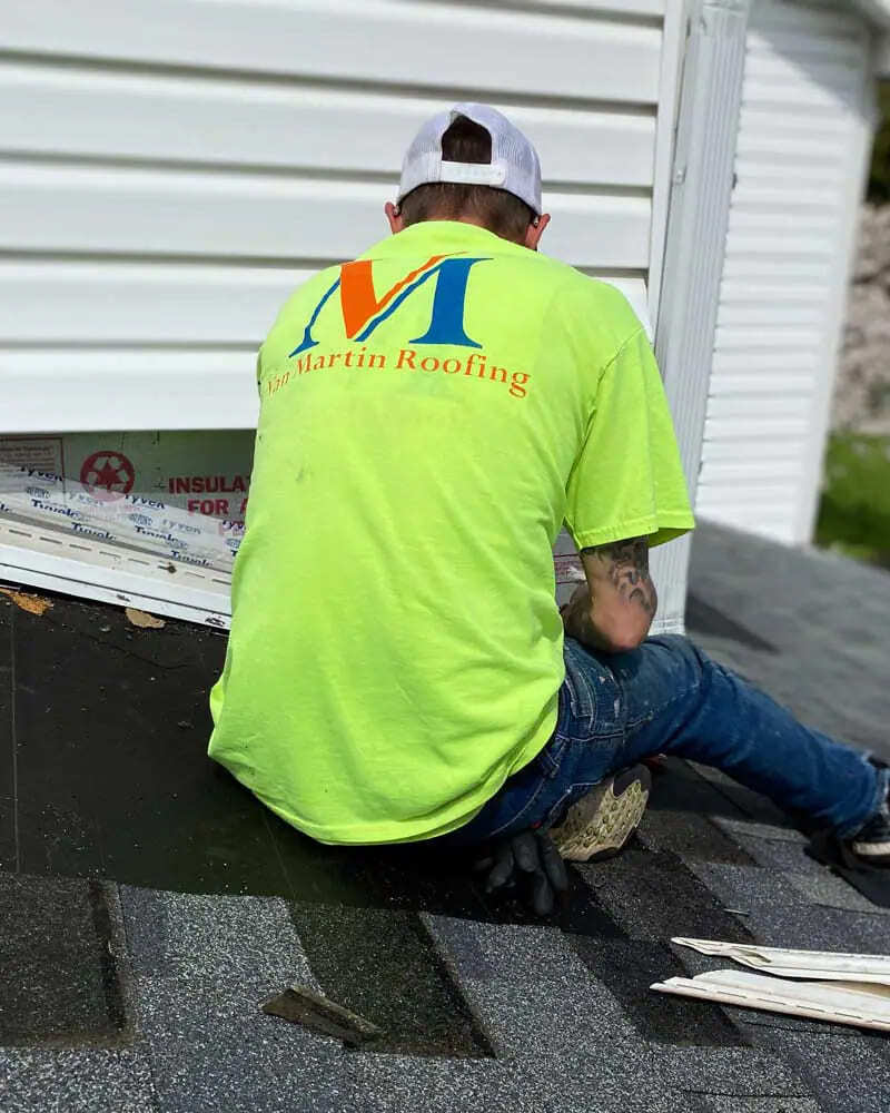 roofer replacing roof on residential home