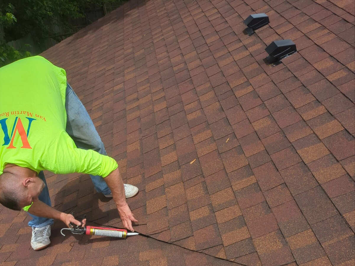 Roofer repairing residential roof