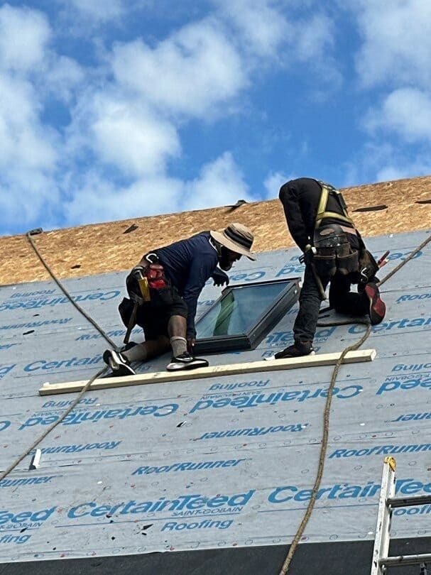 two roofers replacing residential roof